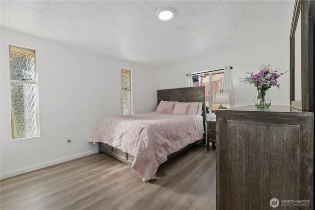 a bedroom with a bed and a window