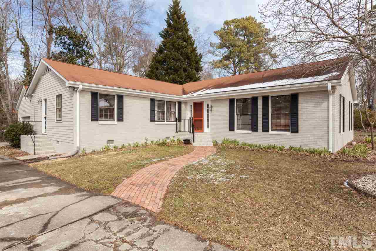 927 Winona Road Raleigh, NC 27609 - Photo 1 of 16 a front view of a house with a garden