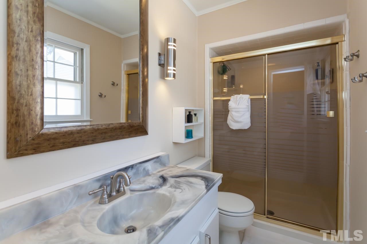 927 Winona Road Raleigh, NC 27609 - Photo 13 of 16 a bathroom with a sink toilet and shower
