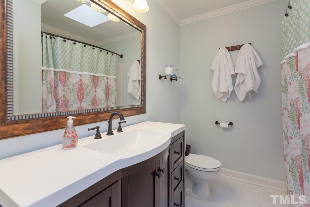 927 Winona Road Raleigh, NC 27609 - Photo 14 of 16 a bathroom with a sink vanity mirror and toilet