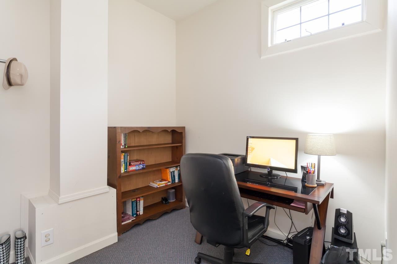 927 Winona Road Raleigh, NC 27609 - Photo 9 of 16 a view of a workspace with furniture and a window