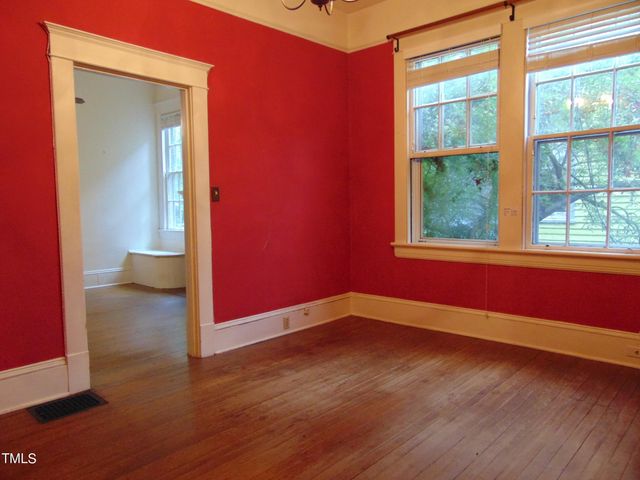 a view of an entryway with wooden floor and door