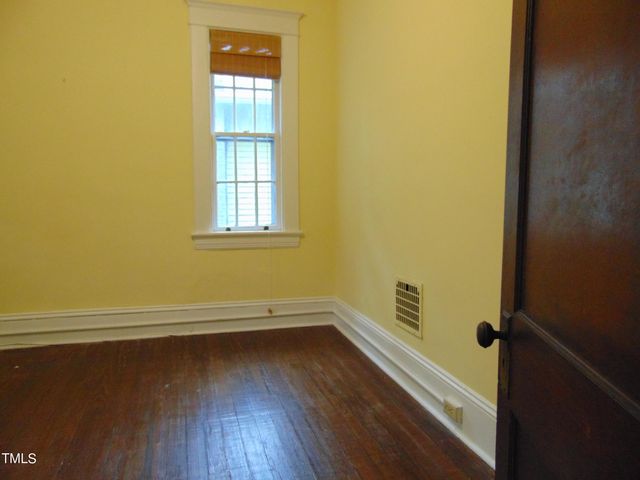 an empty room with wooden floor