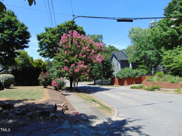 a view of a house with a tree in the background
