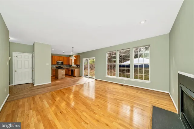 a view of empty room with a kitchen