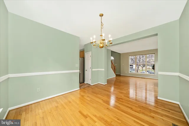 a spacious bedroom with a bed and a chandelier