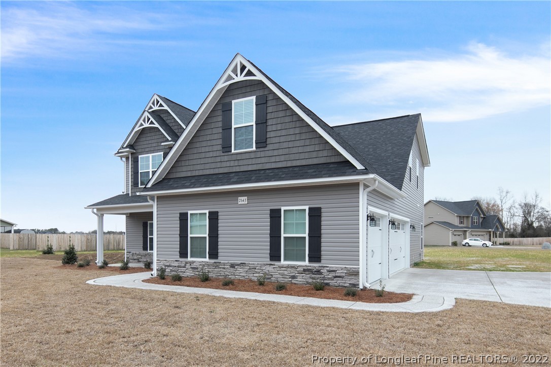 2643 Riddle Farm Hope Mills, NC 28348 - Photo 2 of 50 a front view of a house with a yard