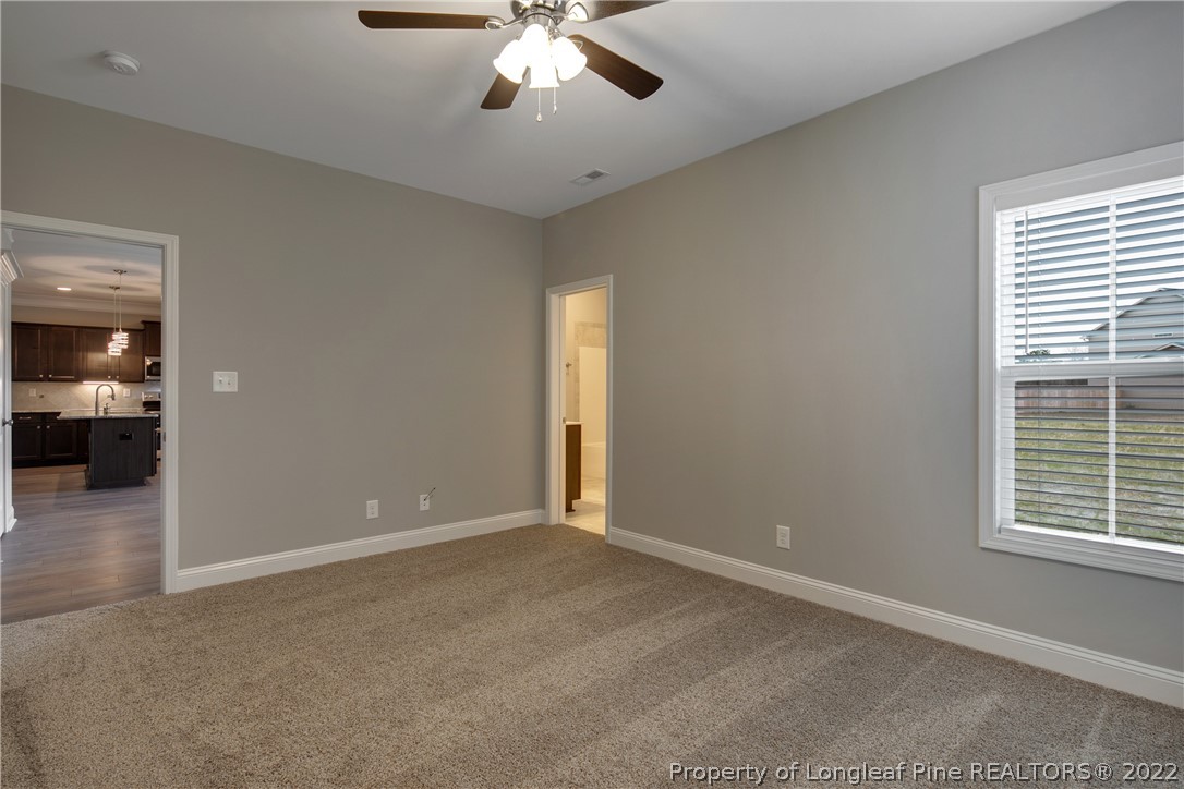 2643 Riddle Farm Hope Mills, NC 28348 - Photo 25 of 50 an empty room with chandelier fan and windows