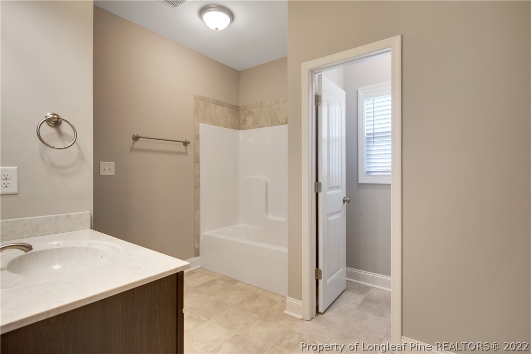 2643 Riddle Farm Hope Mills, NC 28348 - Photo 28 of 50 a bathroom with a sink a mirror and a shower