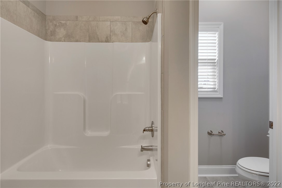 2643 Riddle Farm Hope Mills, NC 28348 - Photo 30 of 50 a bathroom with a bathtub and a shower