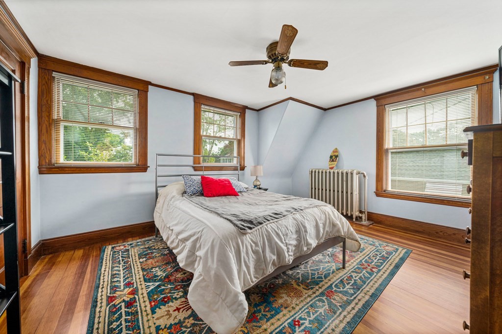 88 Independence Street Canton, MA 02021 - Photo 18 of 30 a bedroom with a bed and wooden floor