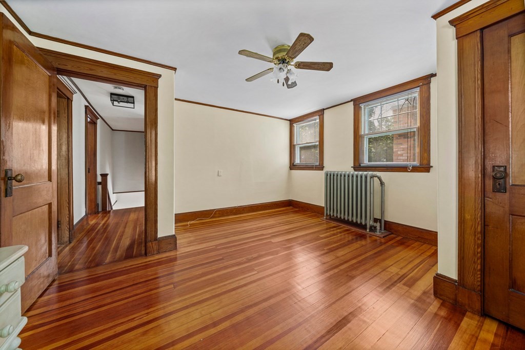 88 Independence Street Canton, MA 02021 - Photo 23 of 30 a view of an empty room with wooden floor and a window