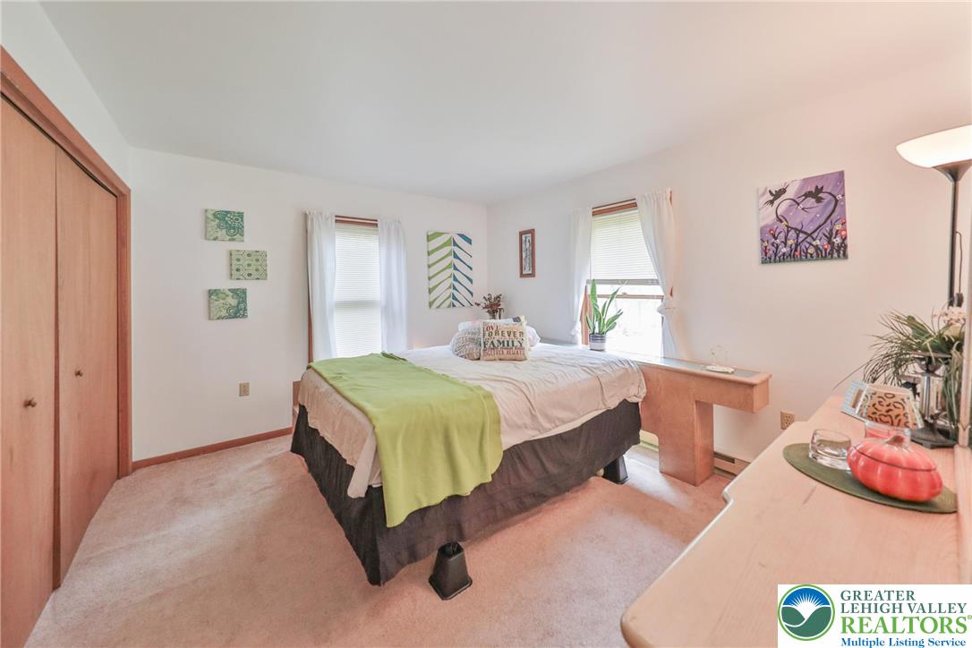 4608 Pine Ridge Drive West Bushkill, PA 18324 - Photo 40 of 62 Plush carpeting creates a serene atmosphere for this well-lit bedroom with ample closet space.
