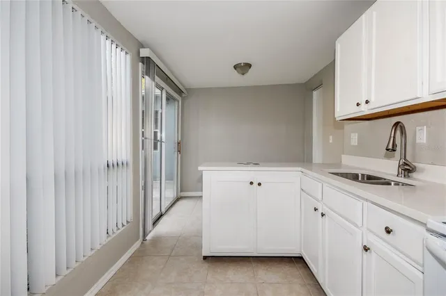 a view of a kitchen with white cabinets
