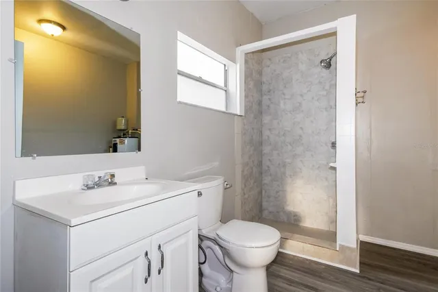 a bathroom with a sink toilet and shower