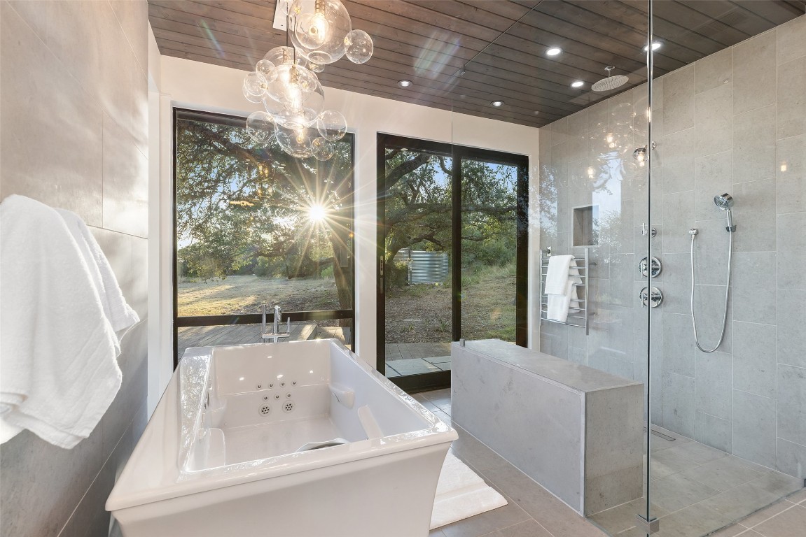201 Gold Nugget Road Wimberley, TX 78676 - Photo 17 of 40 a bathroom with a tub shower and sink