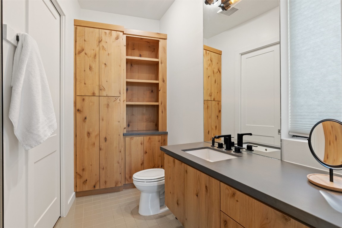 201 Gold Nugget Road Wimberley, TX 78676 - Photo 19 of 40 a bathroom with a sink a toilet and a shower