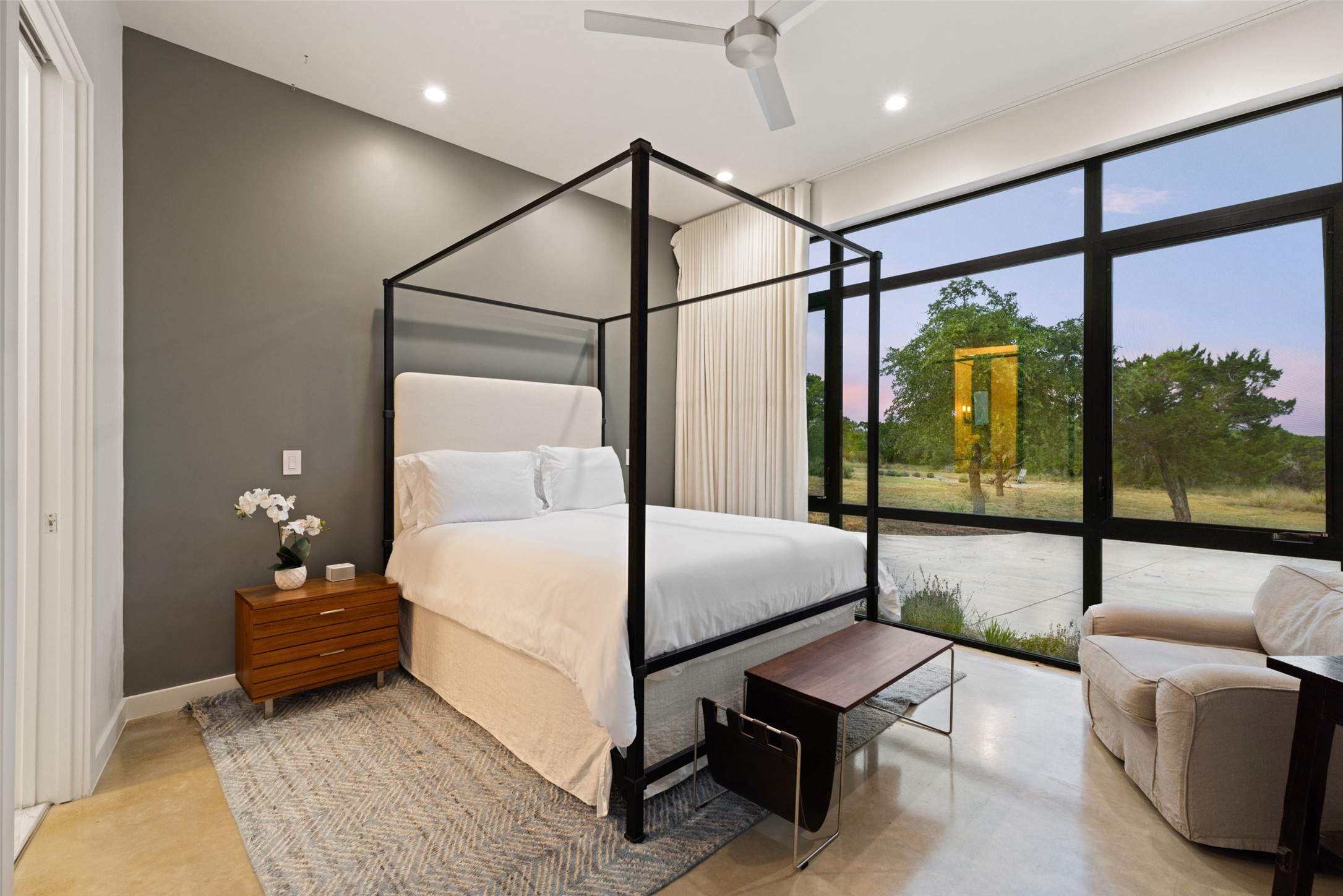 201 Gold Nugget Road Wimberley, TX 78676 - Photo 22 of 40 a bedroom with a bed and a glass walk in closet