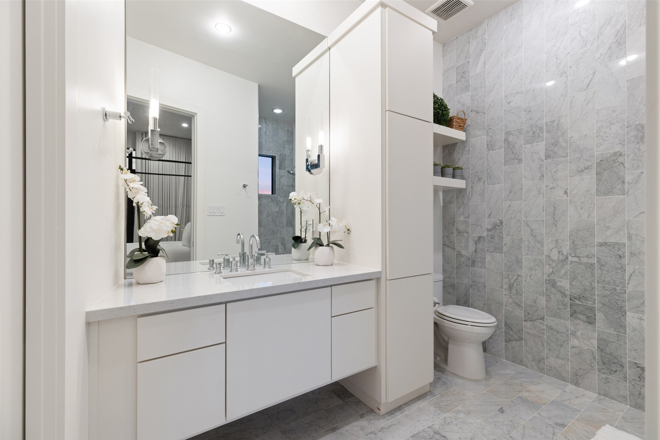 201 Gold Nugget Road Wimberley, TX 78676 - Photo 23 of 40 a bathroom with a double vanity sink toilet and shower