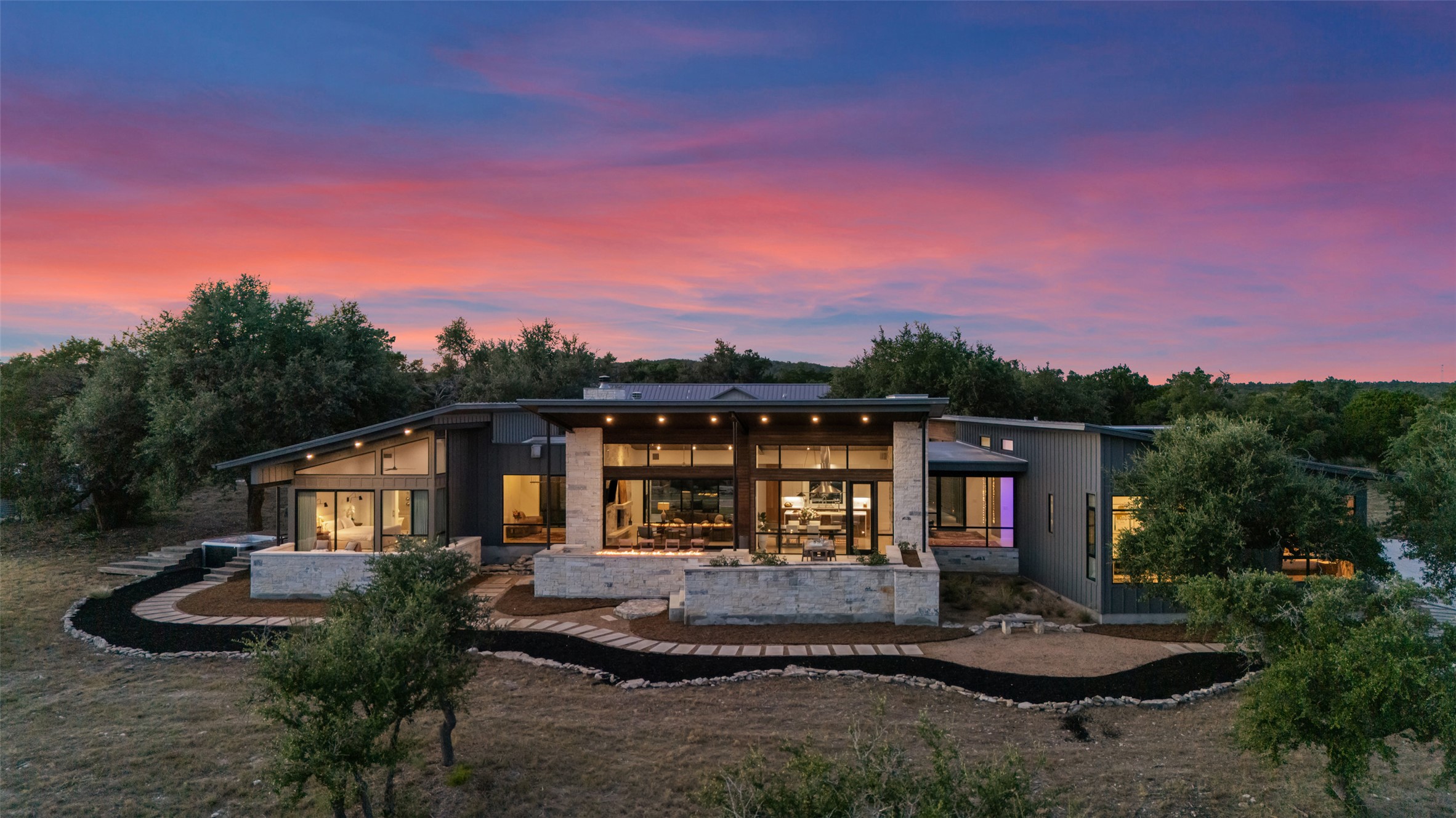 201 Gold Nugget Road Wimberley, TX 78676 - Photo 39 of 40 a front view of a house with a garden and trees