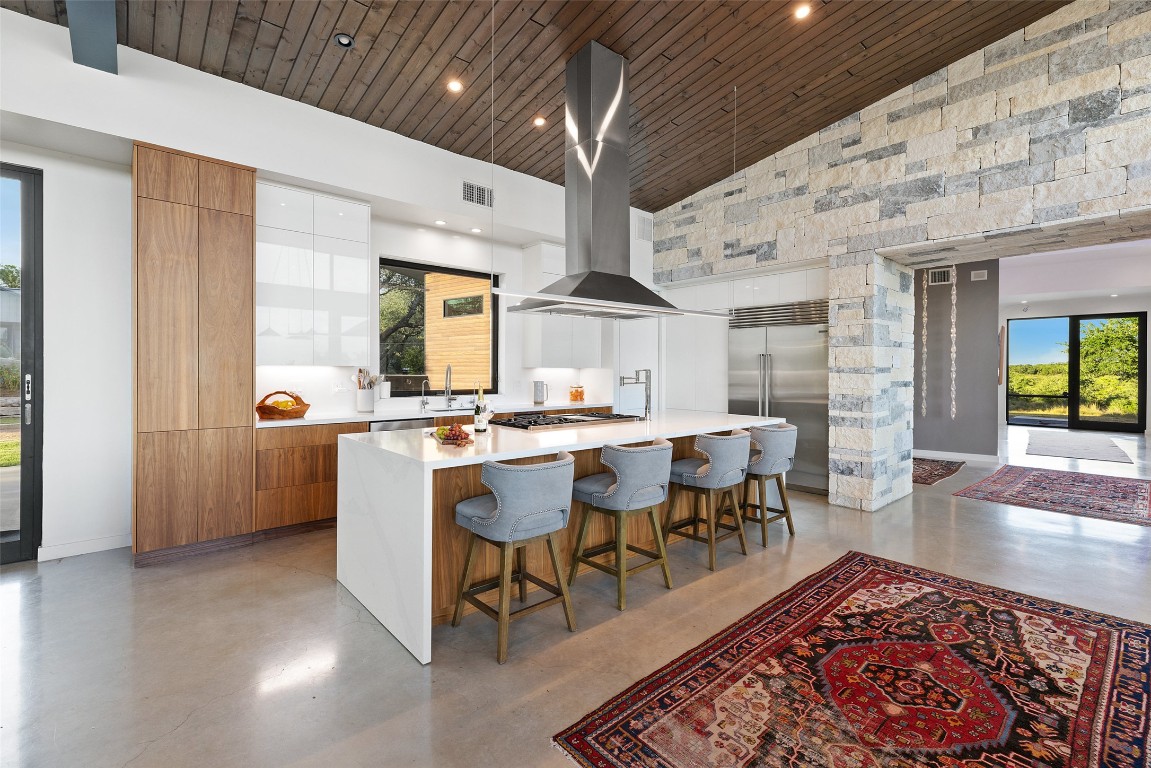201 Gold Nugget Road Wimberley, TX 78676 - Photo 9 of 40 a living room with furniture a rug and kitchen view