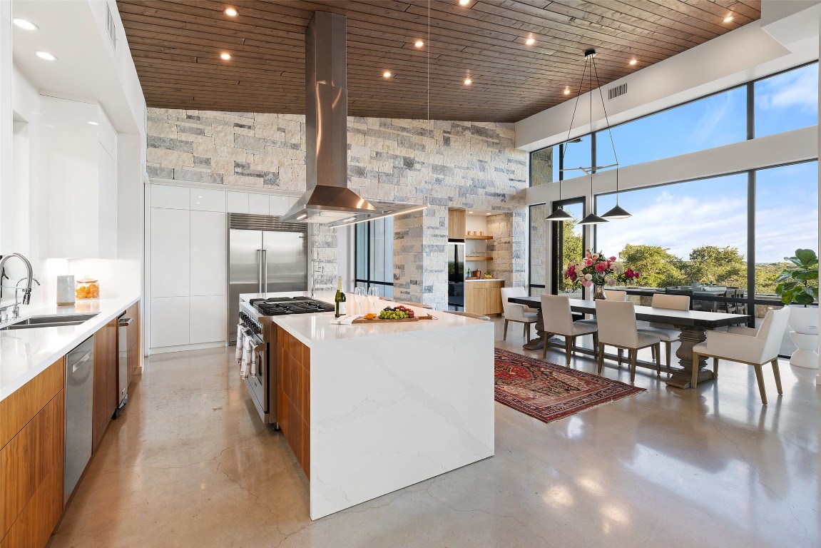 201 Gold Nugget Road Wimberley, TX 78676 - Photo 10 of 40 a kitchen with stainless steel appliances granite countertop a stove and a refrigerator