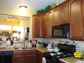 613 Colbert Way Fort Mill, SC 29715 - Photo 2 of 16 a kitchen with granite countertop a stove a sink and a wooden cabinets