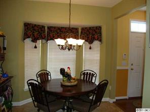 613 Colbert Way Fort Mill, SC 29715 - Photo 3 of 16 a view of a dining room with furniture and chandelier