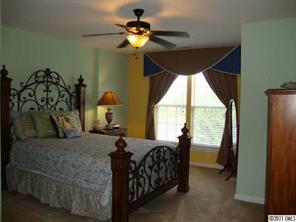 613 Colbert Way Fort Mill, SC 29715 - Photo 9 of 16 a bedroom with a bed and a chandelier