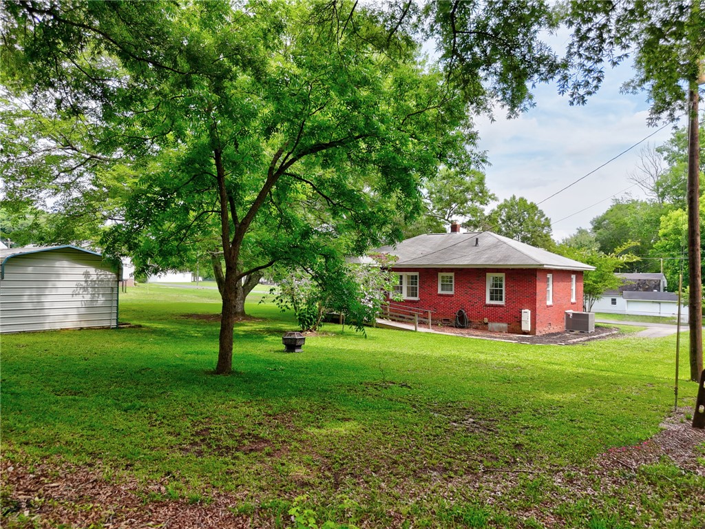 102 Graham Honea Path, SC 29654 - Photo 24 of 29 A well-maintained brick house nestled in a verdant, expansive yard.