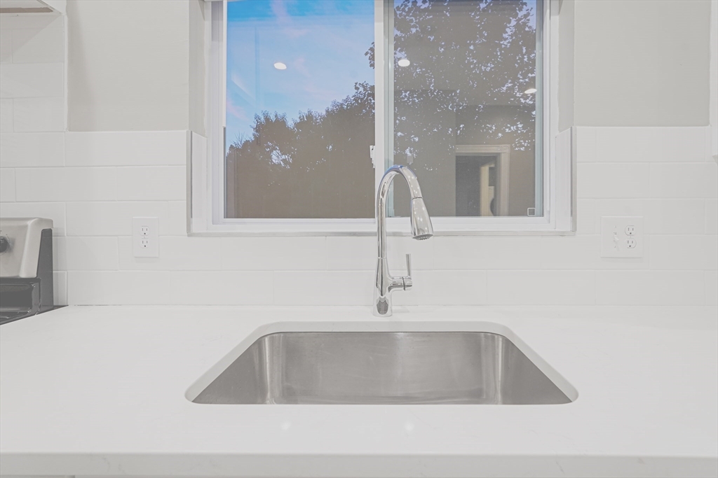 381 Adams Street, Unit 2 Boston, MA 02122 - Photo 2 of 42 a kitchen with a sink and a mirror