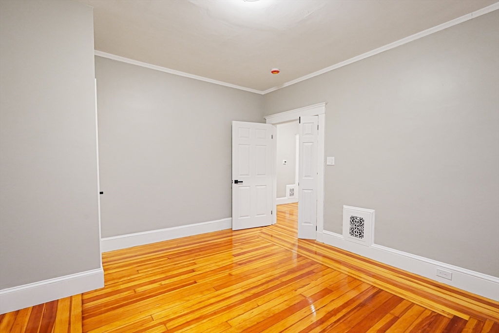 381 Adams Street, Unit 2 Boston, MA 02122 - Photo 23 of 42 a view of a room with wooden floor