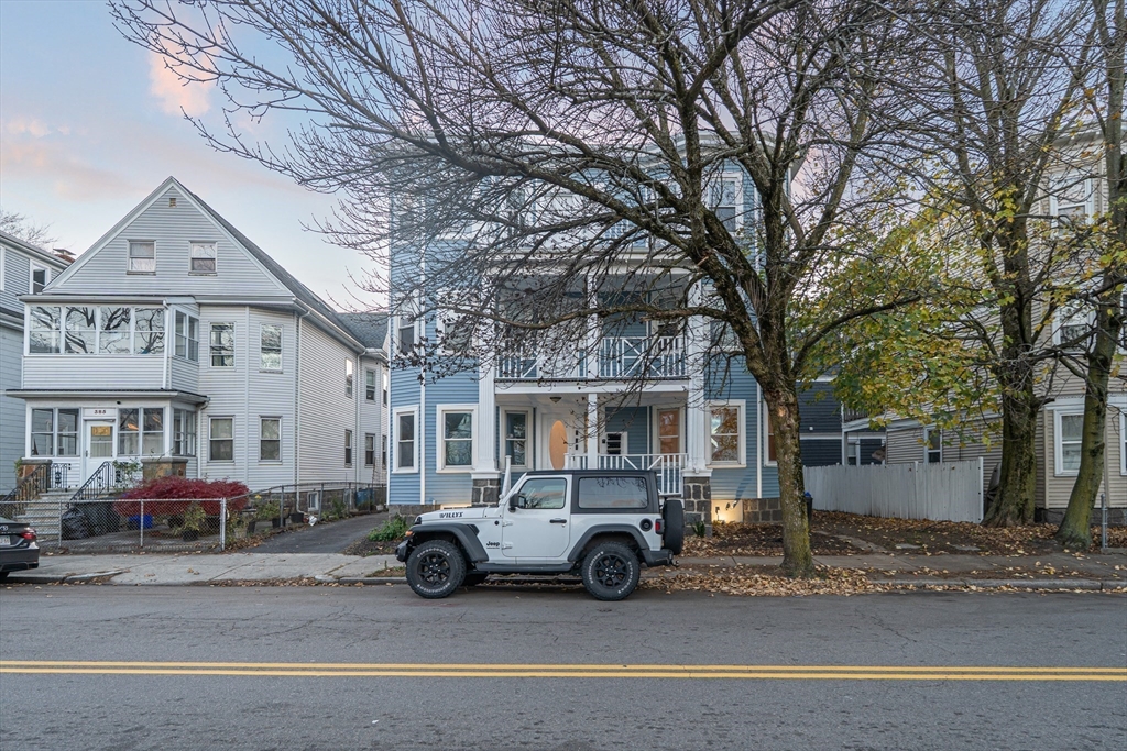 381 Adams Street, Unit 2 Boston, MA 02122 - Photo 34 of 42 a view of a city street with a parked cars