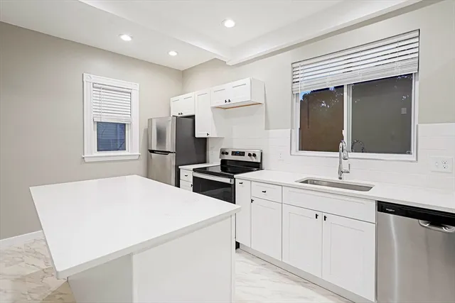 a kitchen with a sink stove and refrigerator