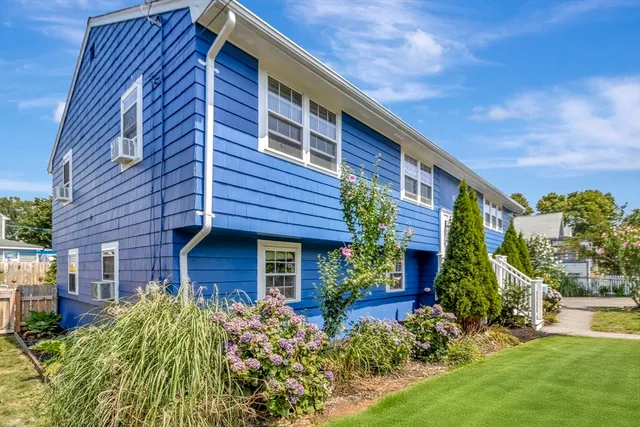 a view of brick house with a yard