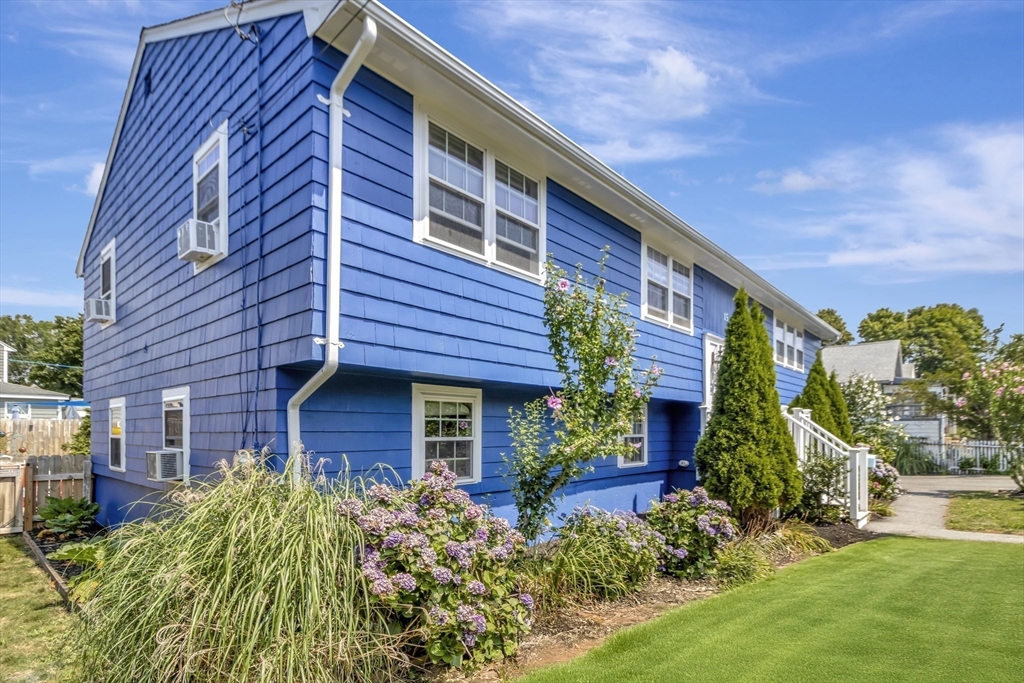 a view of brick house with a yard