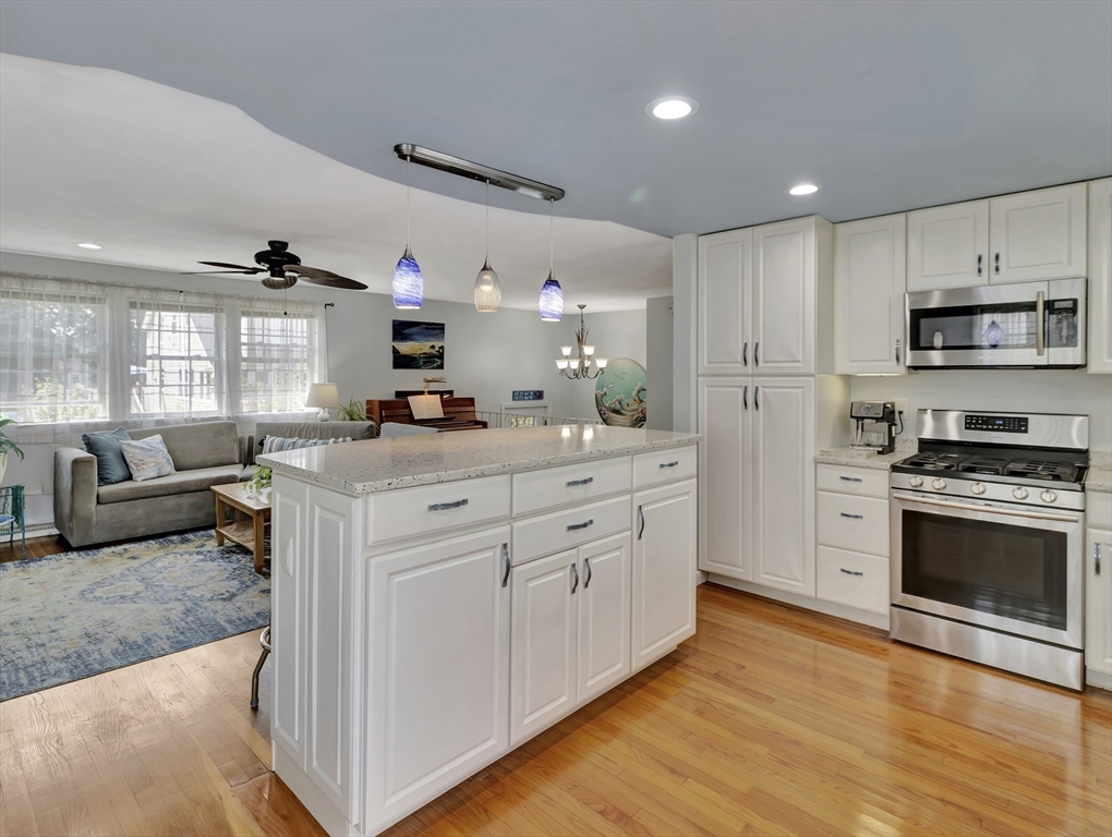 15 H Street Hull, MA 02045 - Photo 13 of 35 a kitchen with stainless steel appliances kitchen island granite countertop a stove a sink and a refrigerator