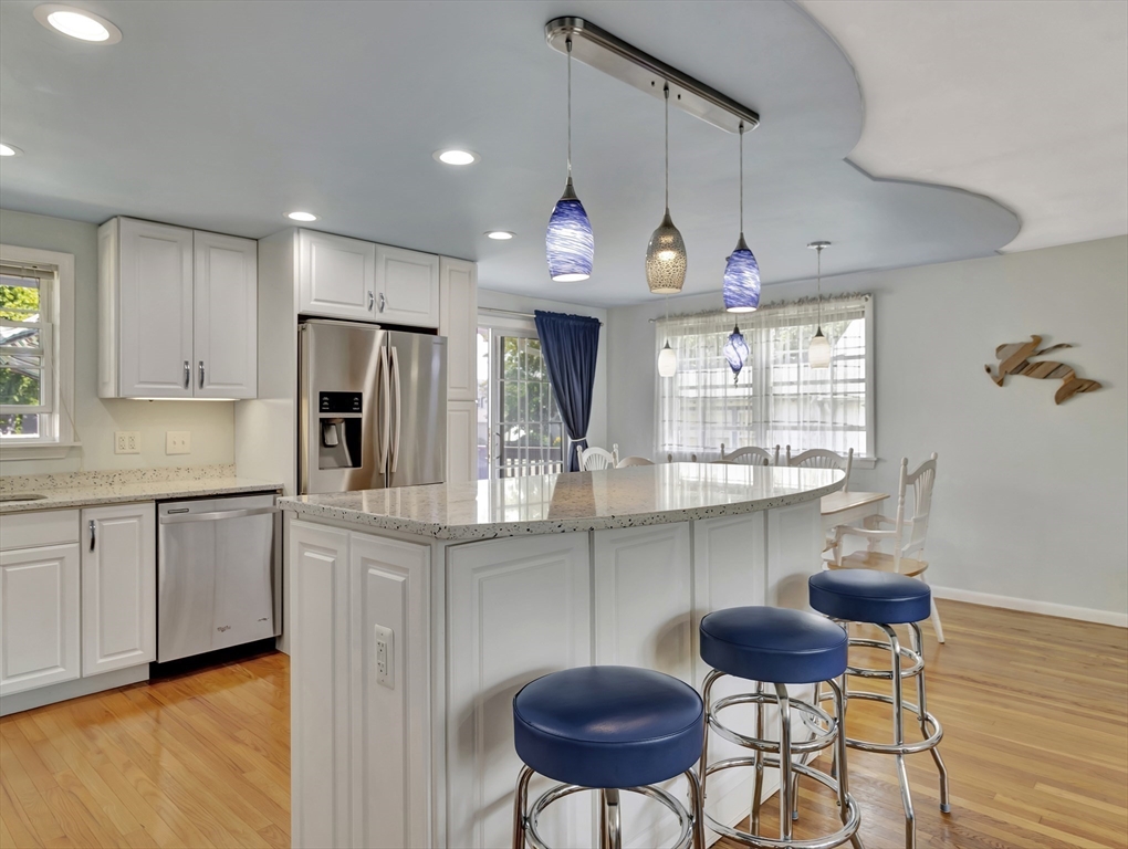 15 H Street Hull, MA 02045 - Photo 14 of 35 a kitchen with stainless steel appliances granite countertop a kitchen island a stove a cabinets a sink and a island