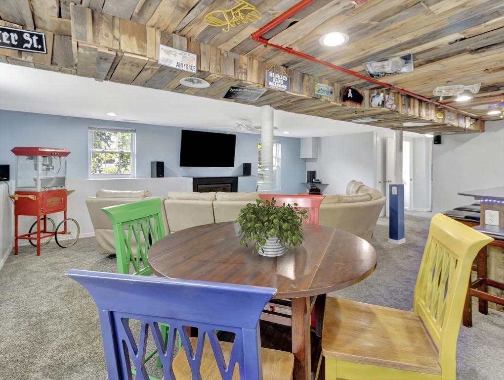 15 H Street Hull, MA 02045 - Photo 29 of 35 a living room with furniture a flat screen tv and kitchen view