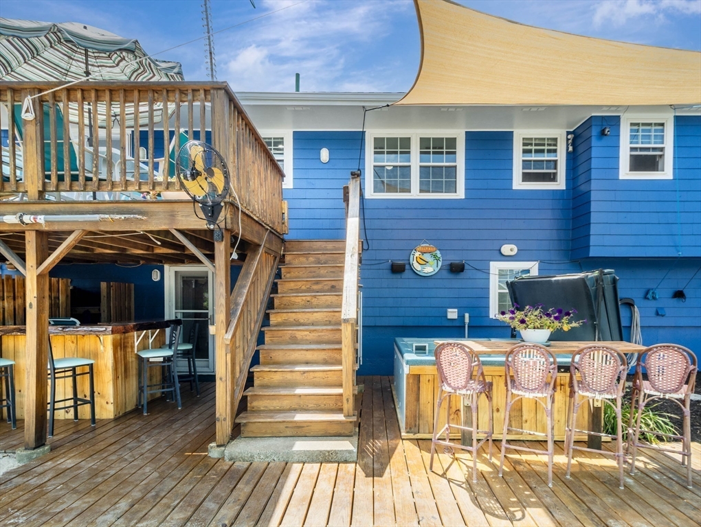 15 H Street Hull, MA 02045 - Photo 5 of 35 a view of a patio with table and chairs with wooden floor and fence