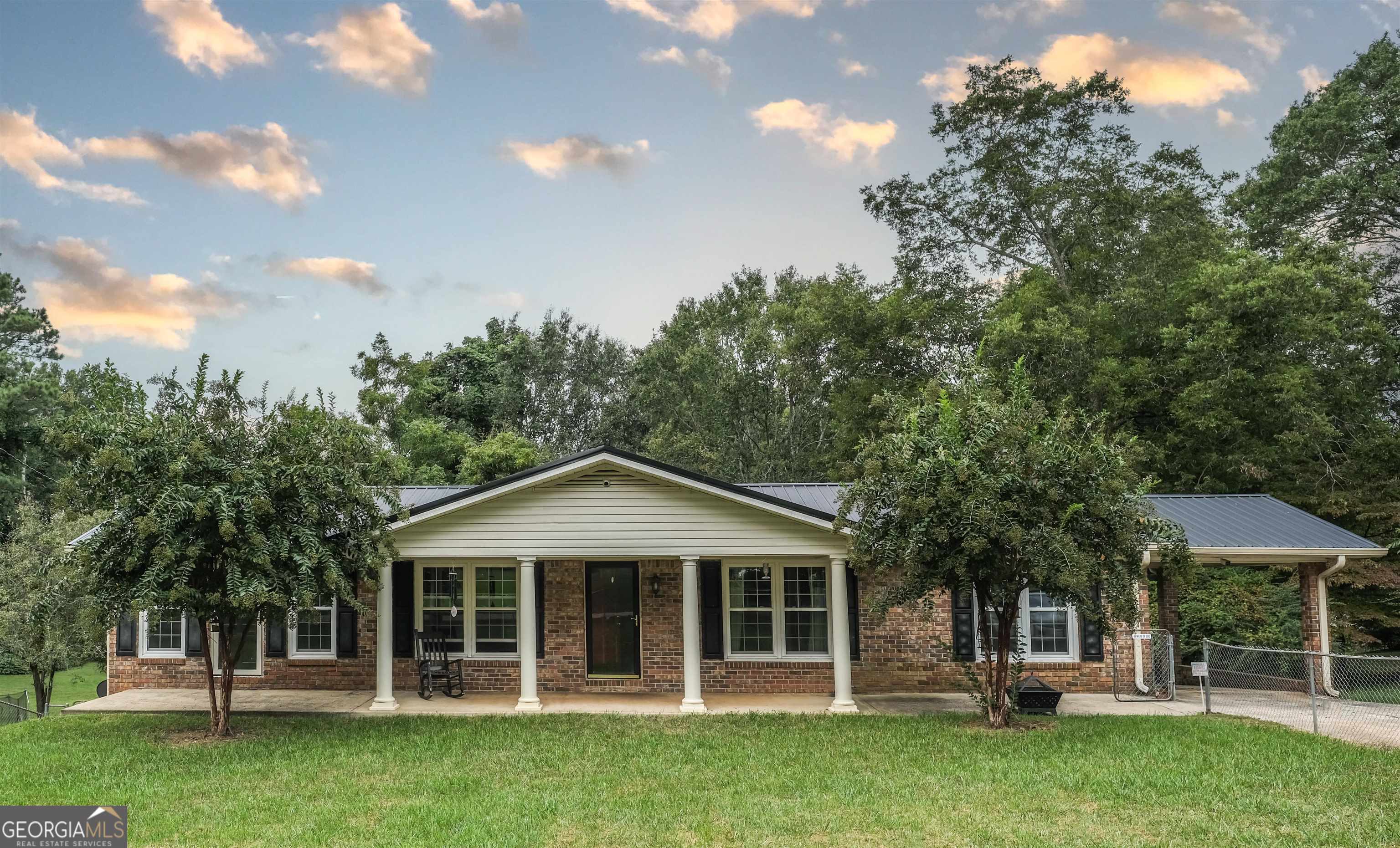 238 Carrollton Street Buchanan, GA 30113 - Photo 1 of 42 a front view of a house with a garden