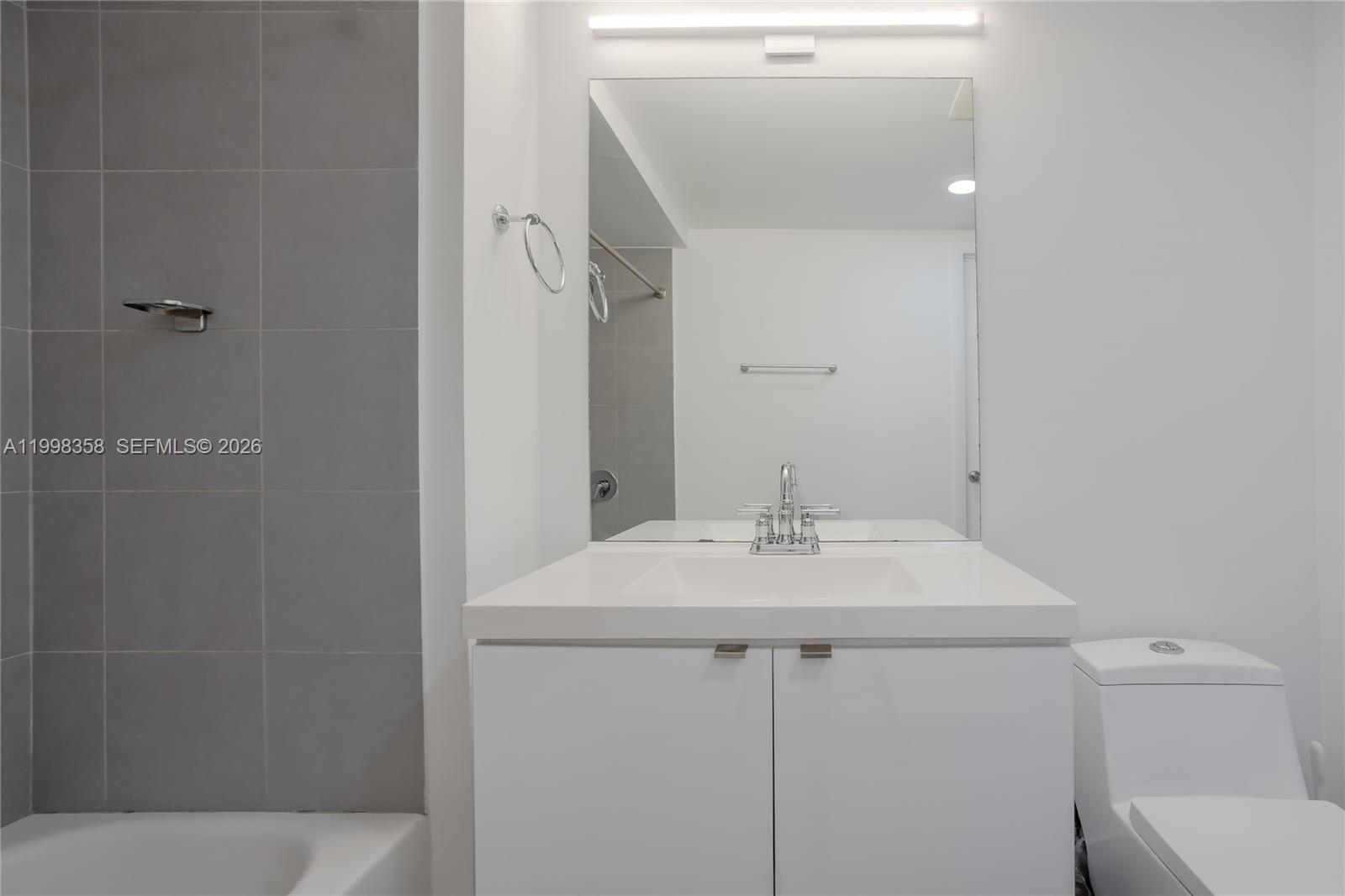 92 Southwest 3rd Street, Unit 3512 Miami, FL 33130 - Photo 16 of 67 a bathroom with a sink a toilet and shower