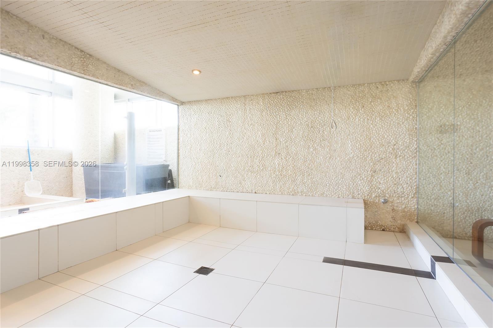 92 Southwest 3rd Street, Unit 3512 Miami, FL 33130 - Photo 65 of 67 a large white tub sitting in a bathroom