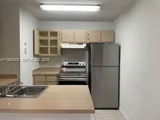 a kitchen with a refrigerator and a sink