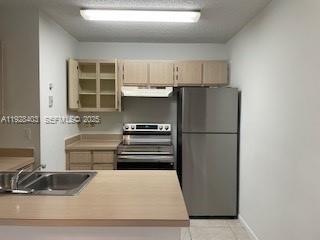 a kitchen with a refrigerator and a sink