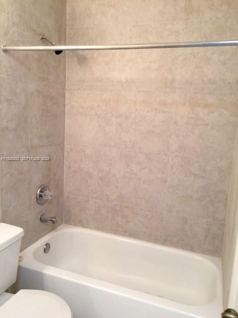 18324 Northwest 68th Avenue, Unit H Hialeah, FL 33015 - Photo 11 of 15 a bathroom with a bathtub and a shower