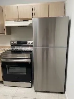a close view of a stove top oven and cabinets