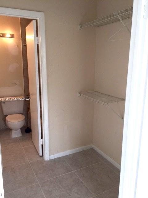 18324 Northwest 68th Avenue, Unit H Hialeah, FL 33015 - Photo 10 of 15 a view of bathroom with a toilet and a shower