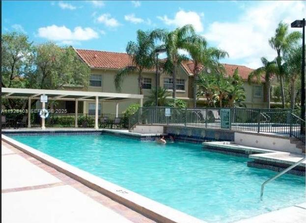 18324 Northwest 68th Avenue, Unit H Hialeah, FL 33015 - Photo 10 of 13 a view of a house with a backyard and swimming pool