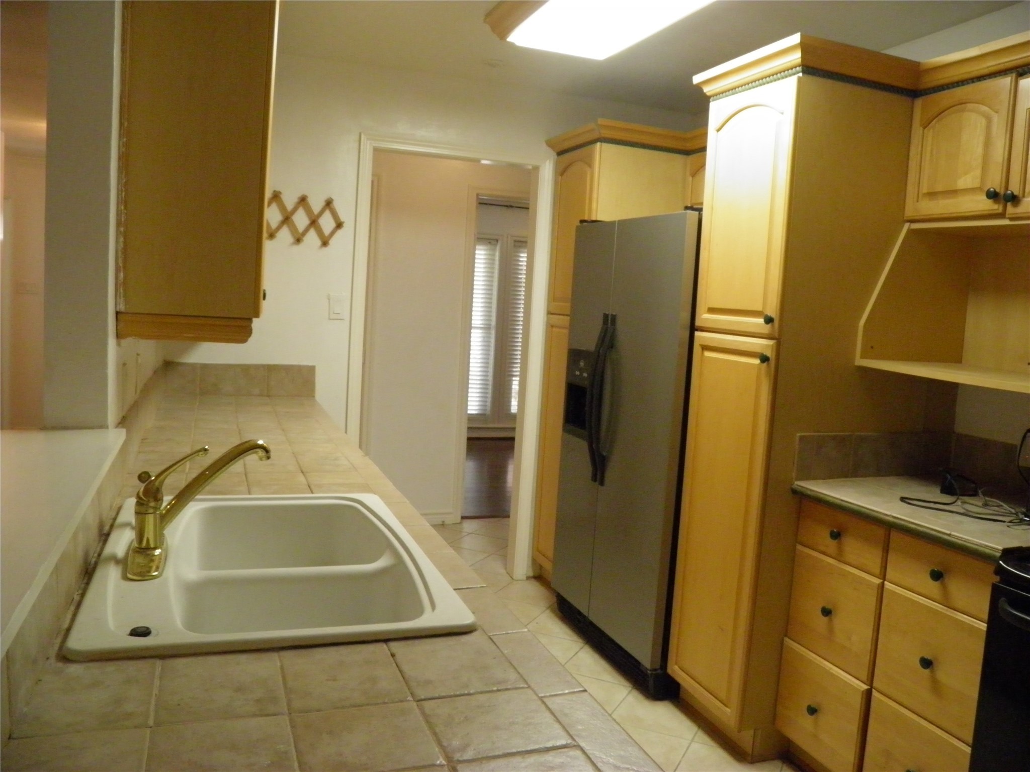 8827 Neff Street Houston, TX 77036 - Photo 6 of 12 a bathroom with a sink a mirror and a shower